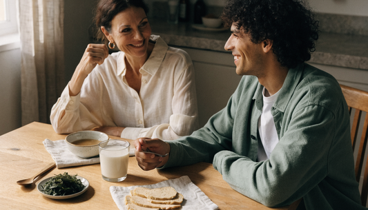 A mother and adult son share a relaxed breakfast with miso soup, sauerkraut, kefir and tempeh, showing how to eat fermented foods every day.