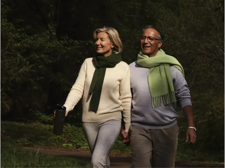 A couple walking together on a sunlit forest path